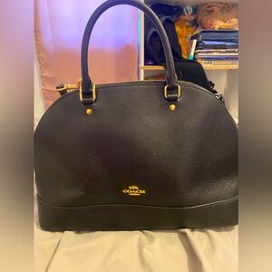 Black coach purse with shorthandle and long strap.